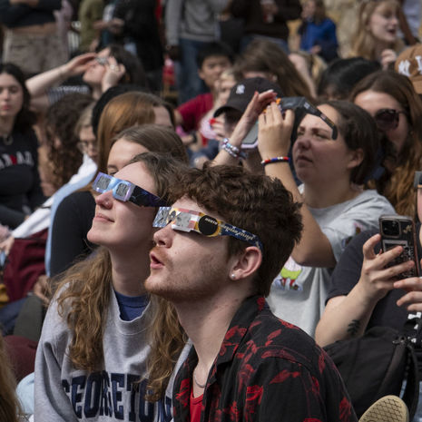 Image of students wearing eclipse glasses to view the April 8 solar eclipse.