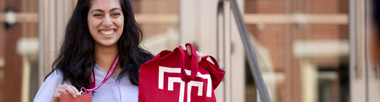 Accepted Temple student with Temple swag.