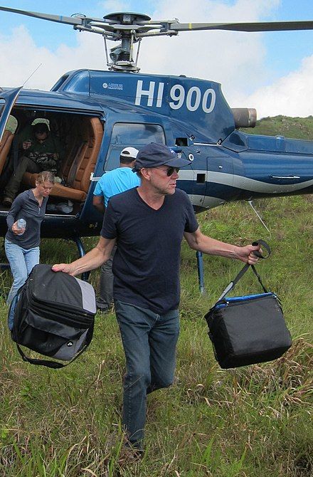 Blair Hedges getting off a helicopter for a science expedition in Haiti