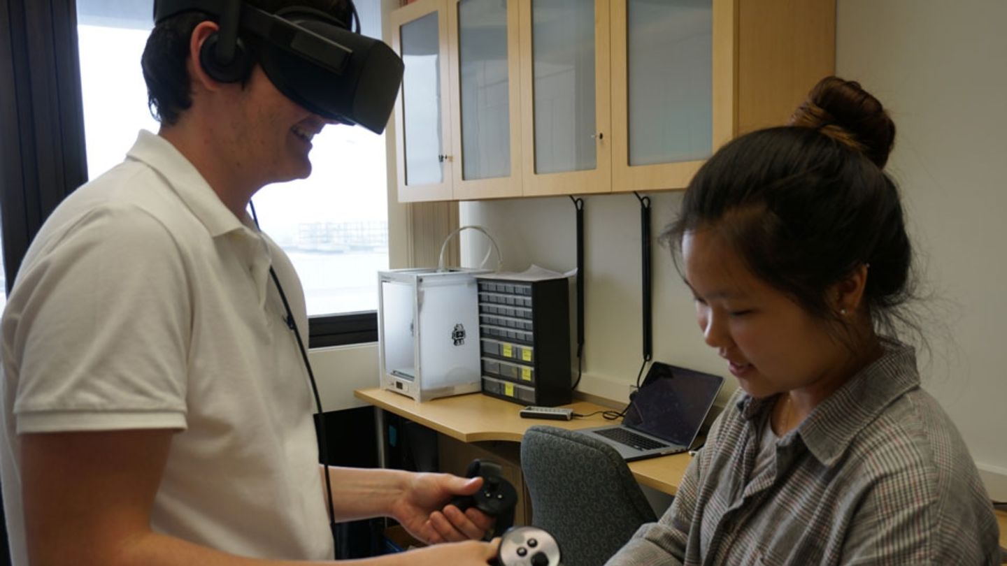Brian Davis, a computer science and mathematics major, and Bella Yang, a computer science major, explore virtual reality software at the new Center for Computational Mathematics and Modeling. Students using virtual reality technology