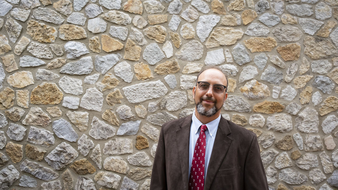 The exterior of Beury Hall, the home of the Department of Earth and Environmental Science, is faced with 500-million-year-old rocks from an ancient beach.
Image of Ilya Buynevich standing in front of a building outlined in rocks