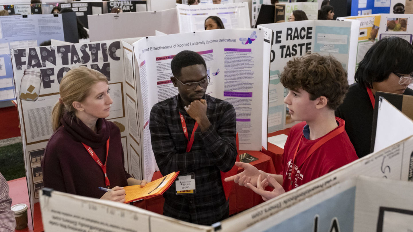 Students' projects cover a range of scientific domains.
Judges and a student at the science fair