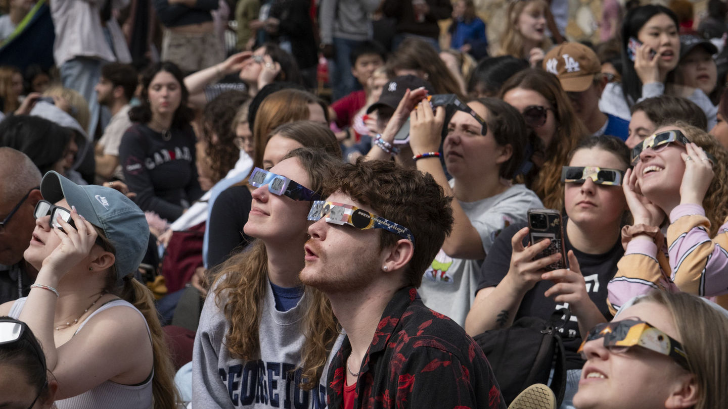 Image of students wearing eclipse glasses to view the April 8 solar eclipse.
